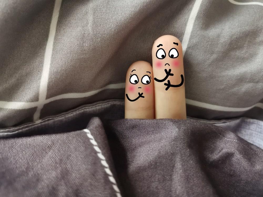 Fingers in Bedsheet With Faces Drawn on Them Concerned About the 15 Foods That Kill Testosterone