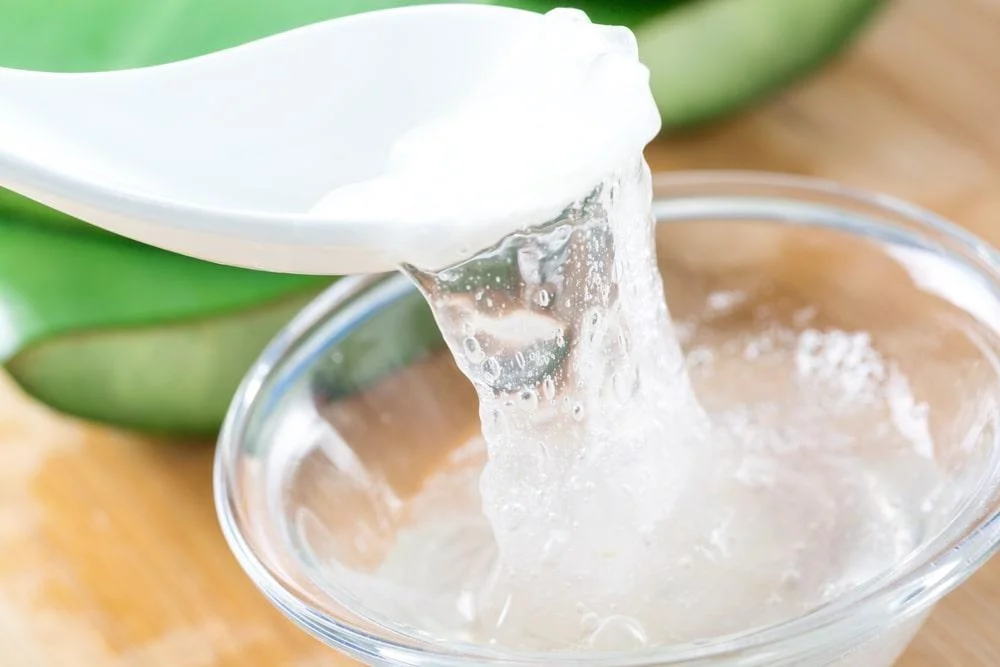 A Spoon Taking Aloe Vera Gel From a Bowl