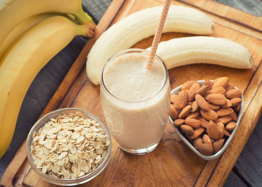 a picture of bananas, a smoothie and a bowl of nuts