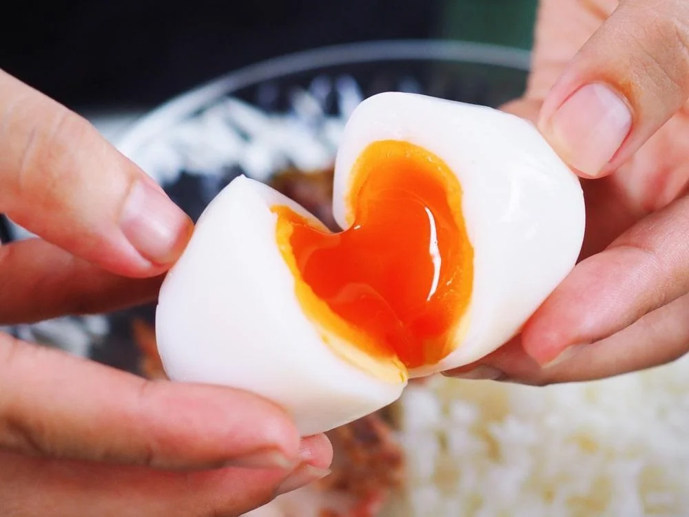 A Person Holding a Hard Boiled Egg Cut In Half