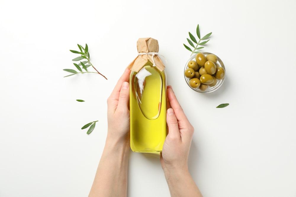 A Person Holding a Bottle of Extra Virgin Olive Oil