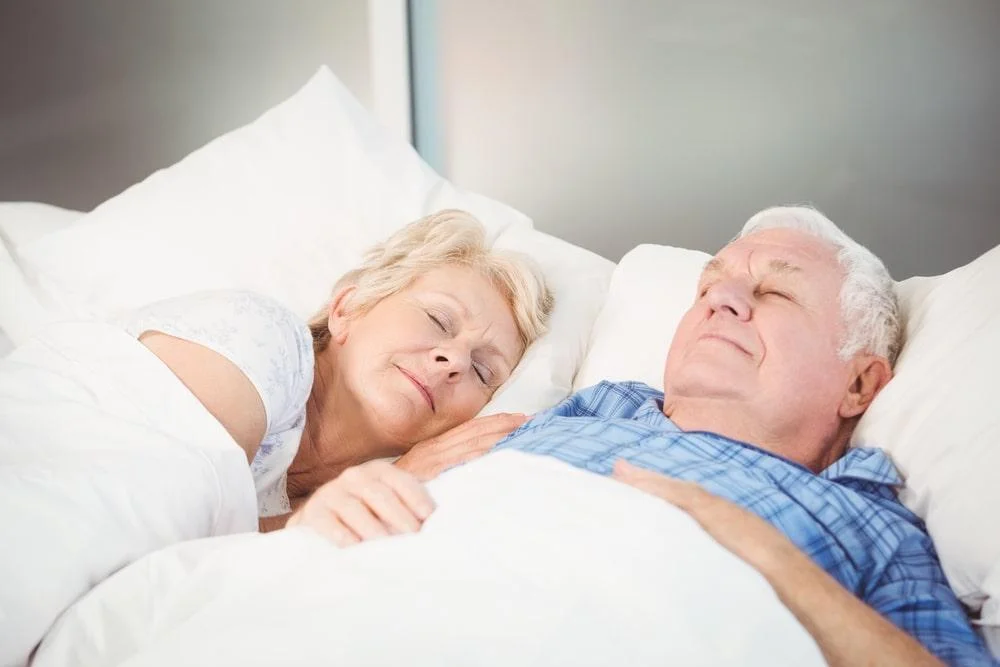 An elderly couple sleeping
