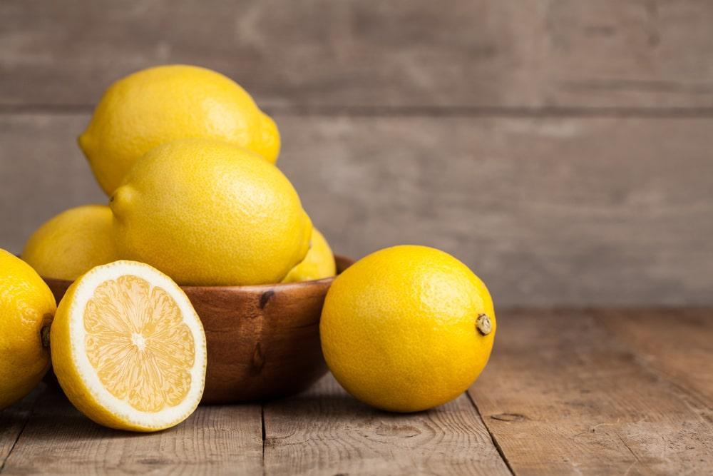 A Bowl of Lemons and a Single Half Lemon
