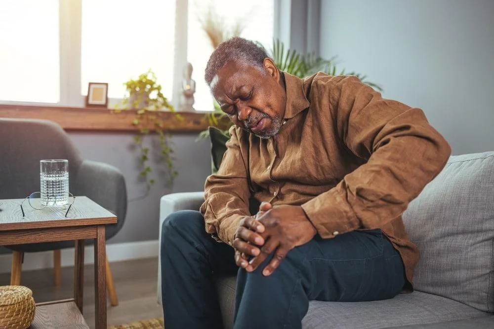 An elderly man experiencing joint pain