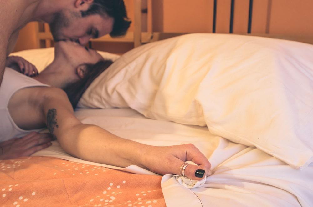Two Opposite Sex People Intimately Kissing in Bed
