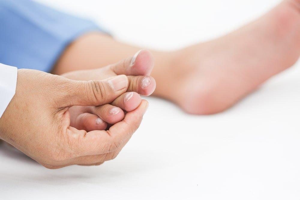 A Woman Touching Her Nails Affected by Fungus and Wondering if Nail Fungus Is Contagious