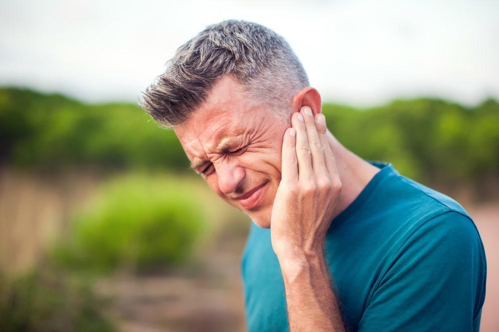 Man Suffering From Tinnitus Before Learning About the 7 Best Supplements for Tinnitus Relief