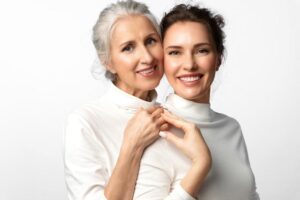 Senior and Young Woman Smiling After Learning 9 Best Supplements for Glowing Skin