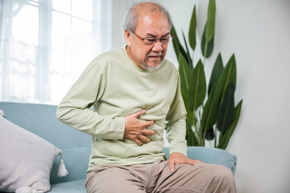 An old man experiencing digestion and bloating