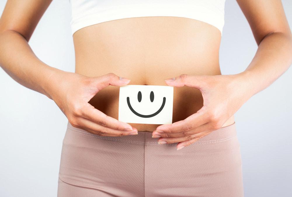 Happy Smiley Face in Hands Near Gut