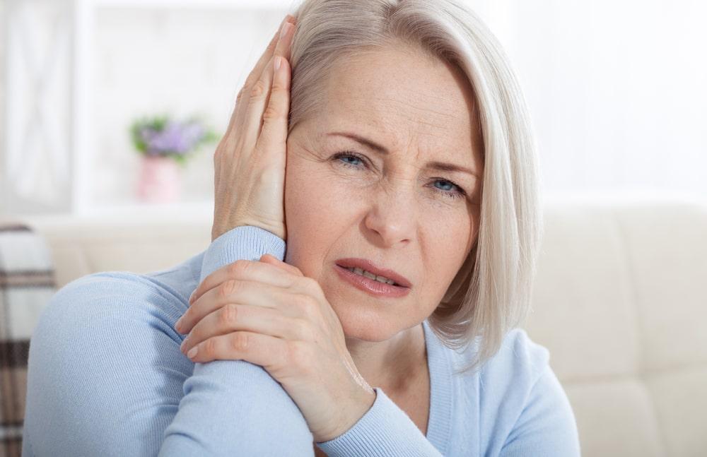 Old Woman Experiencing Tinnitus