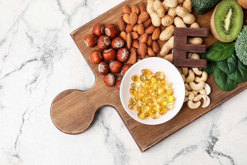 Vitamin E Capsules and Food on a Cutting Board
