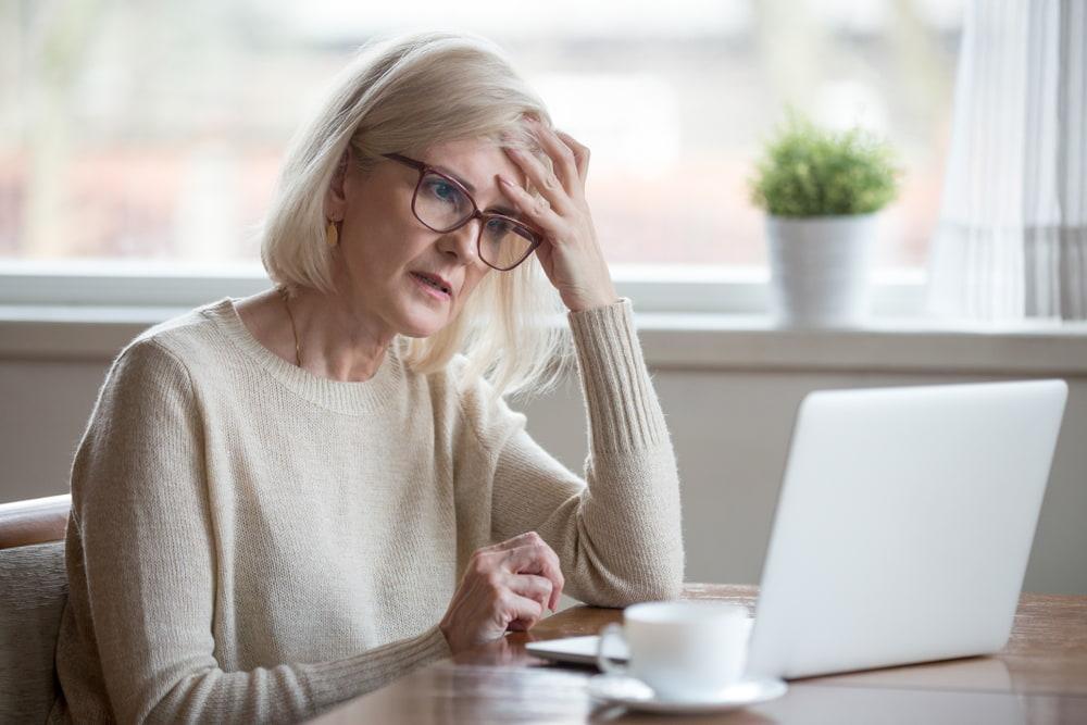 Elderly Woman Frustrated looking at her computer