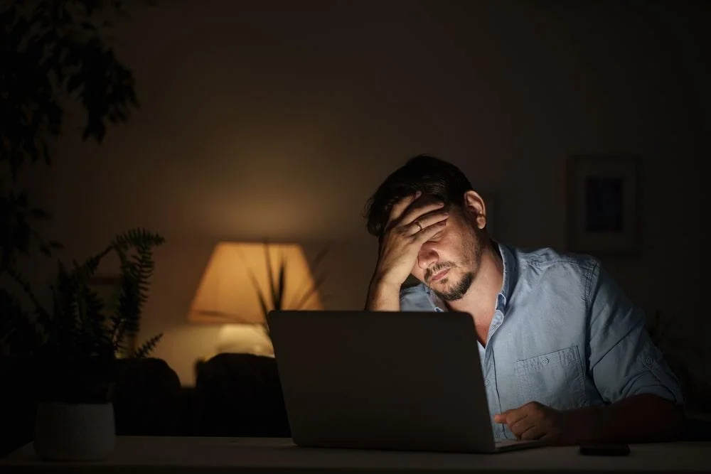 a man holding on his head from frustration