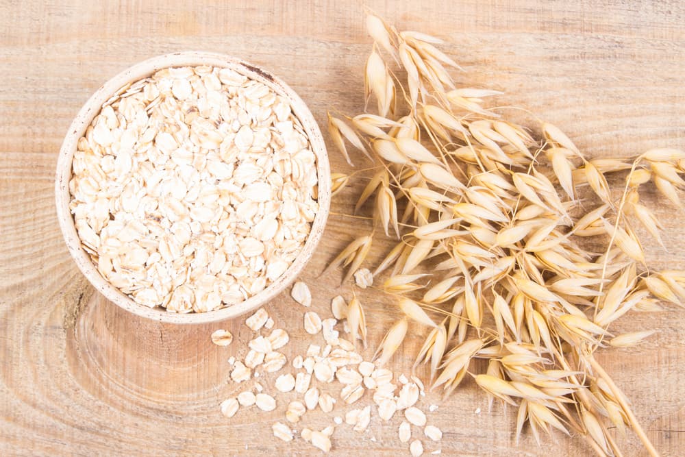 A Bowl of Oatmeal and Oats on a Table