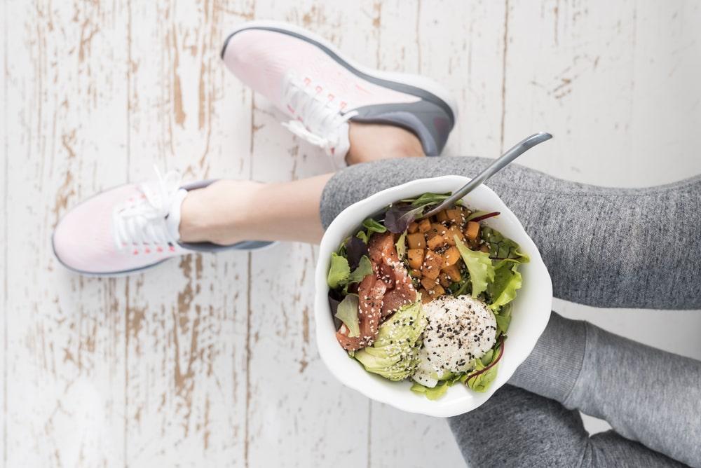 a woman holding a bowl of healthy breakfast