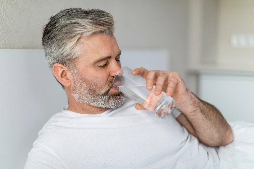 A Man Drinking a Glass of Water