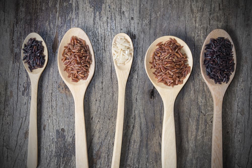 A Row of Wooden Spoons With Different Types of Whole Grains