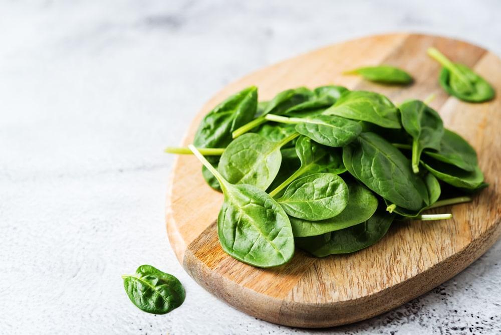 Spinach Leaves on a Wooden Board