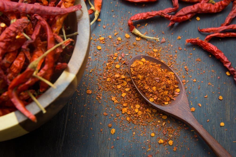 A Wooden Spoon With Cayenne Pepper Flakes