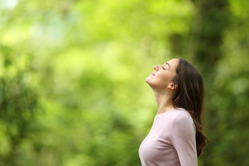 Young Woman Relaxed and Relieved After Learning 10 Signs Your Liver Is Healing