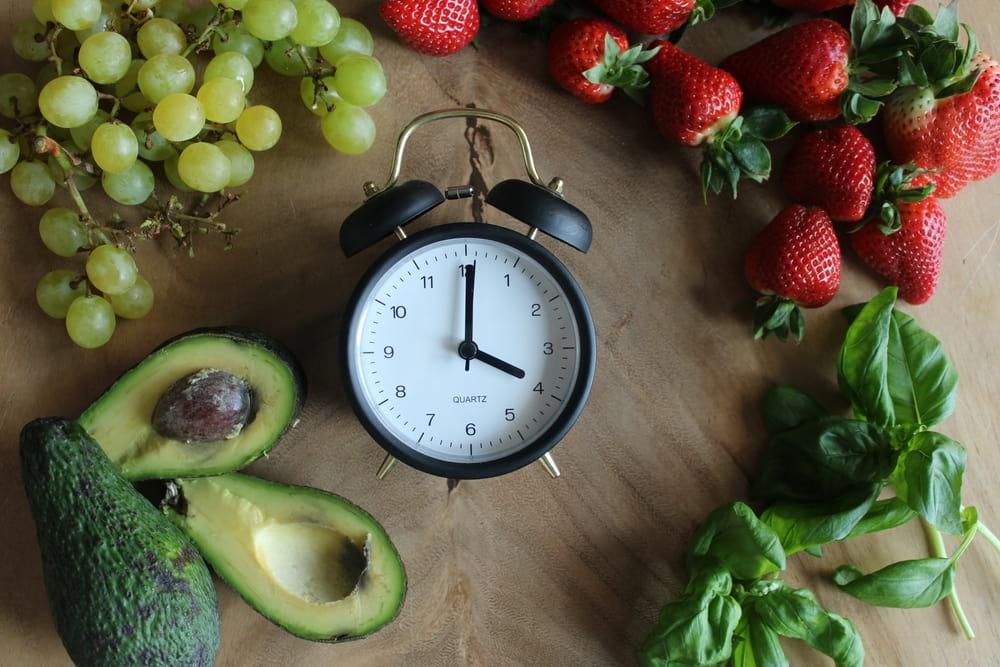 A Clock Surrounded by Different Fruits