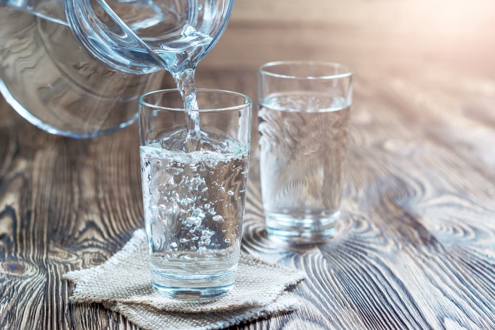 Two Glasses of Water of Which One Is Being Filled