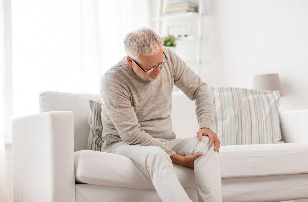 A Man Sitting With SI Joint Pain