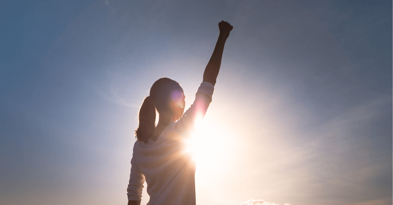 Strong woman holding her hand in the air