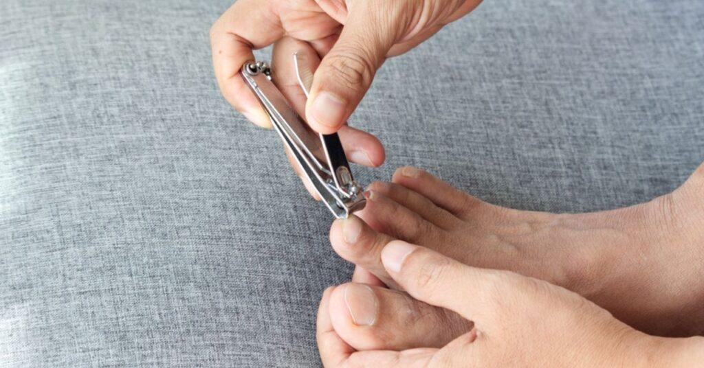 A Person Is Cutting Their Toenails