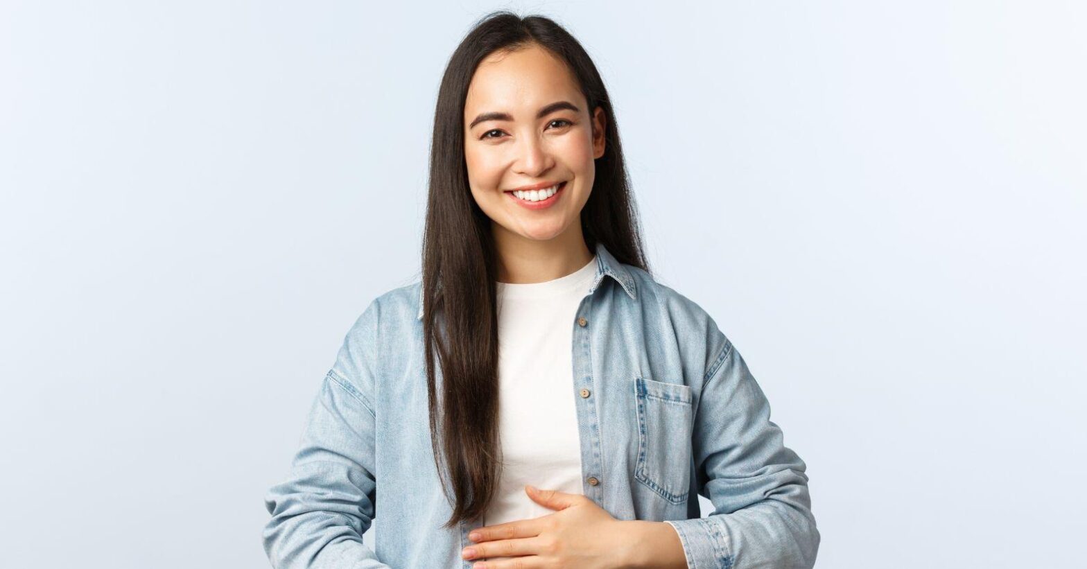 Woman smiling while holding her belly