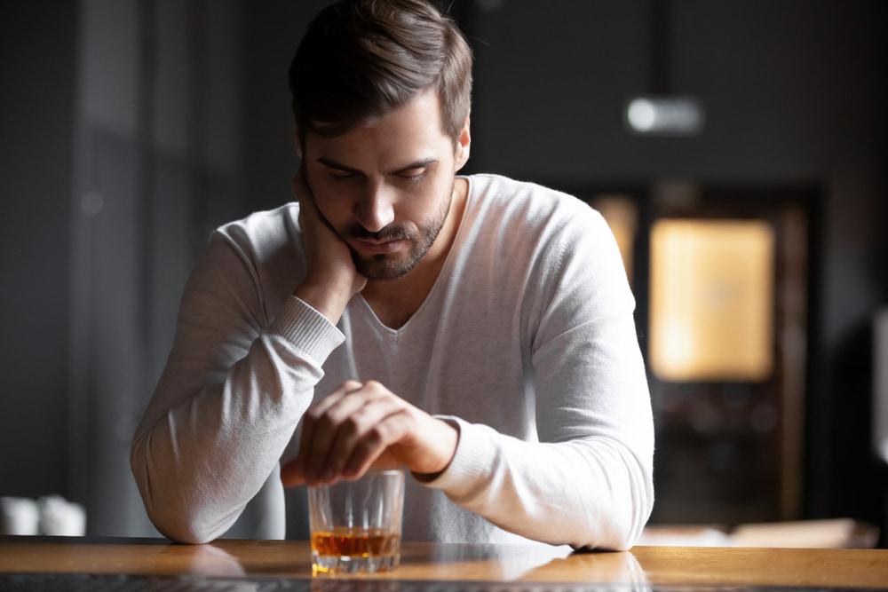 Upset Man Drinking Alcohol in the Bar