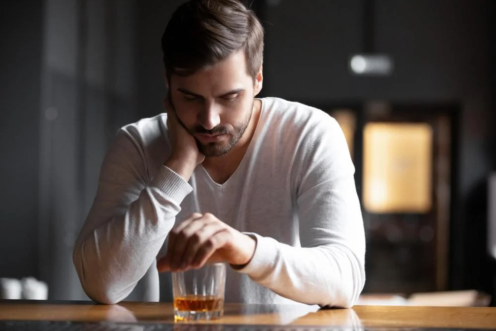Upset Man Drinking Alcohol in the Bar