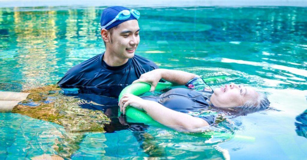 Asian Man or Physiotherapist Helping Elderly Female Patient With Hydrotherapy