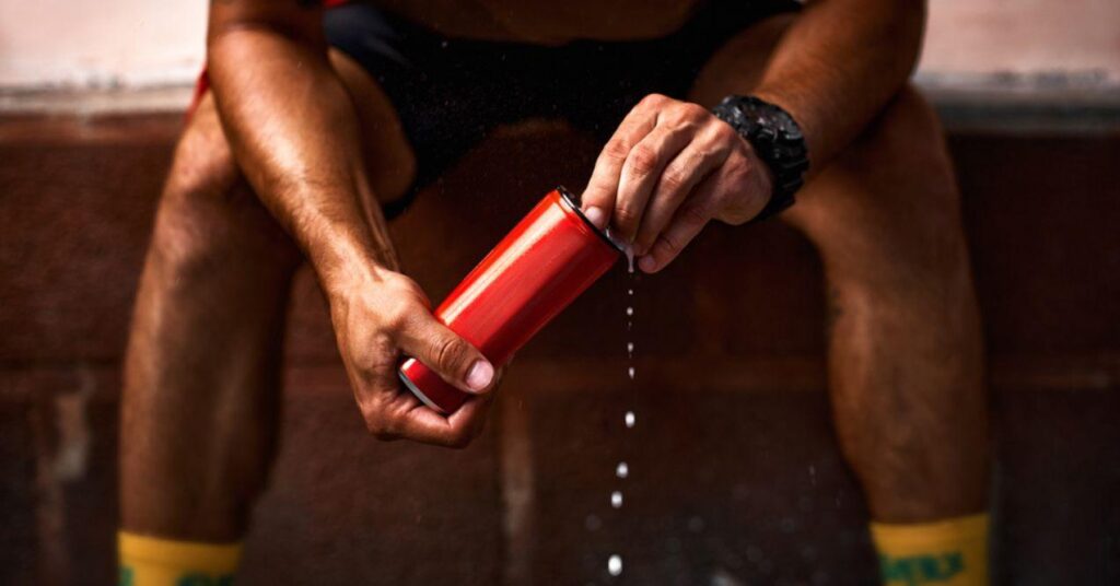 A Man Opening a Red Aluminum Can