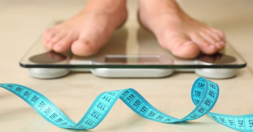 Woman Standing on Floor Scales Indoors