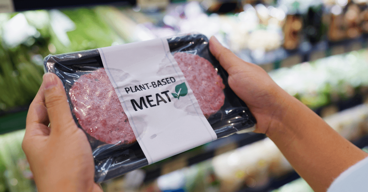 Hands Holding a Package of Plant Based Meat from Soy