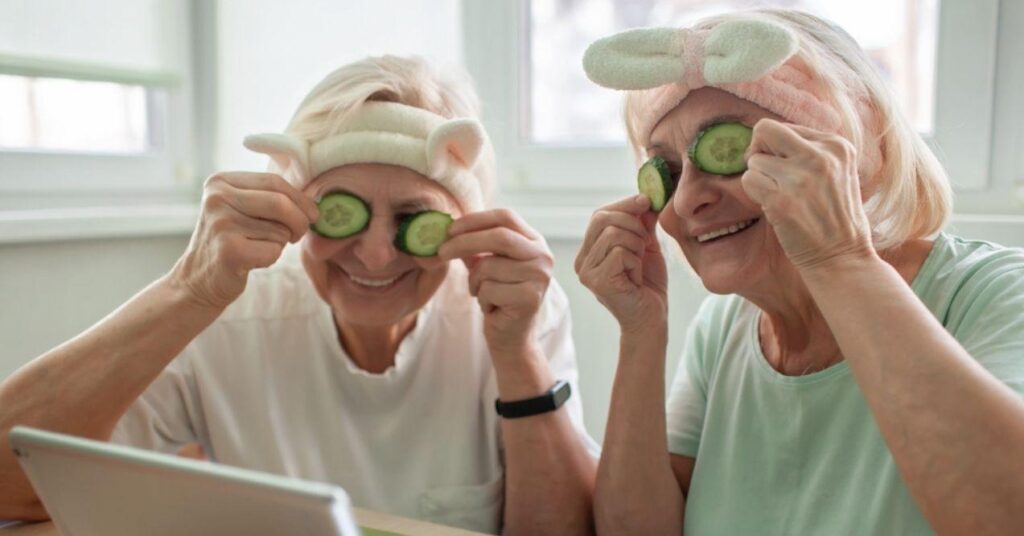 Senior Women Apply Facial Cosmetic Mask and Laughing