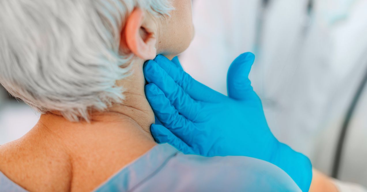 Thyroid gland control. Endocrinology doctor examining senior woman at a clinic.