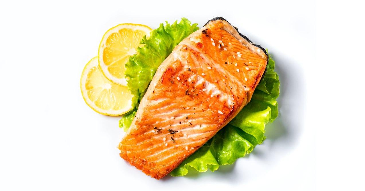 Salmon with lettuce and lemon in white background