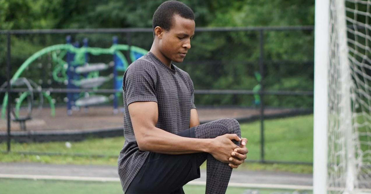 Man doing a warmup exercises for knees before football game