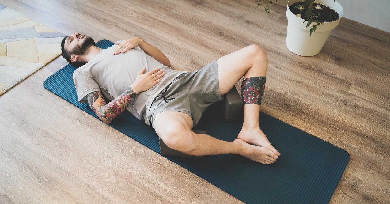 Man Doing Diaphragmatic Breathing Exercise on a Yoga Mat
