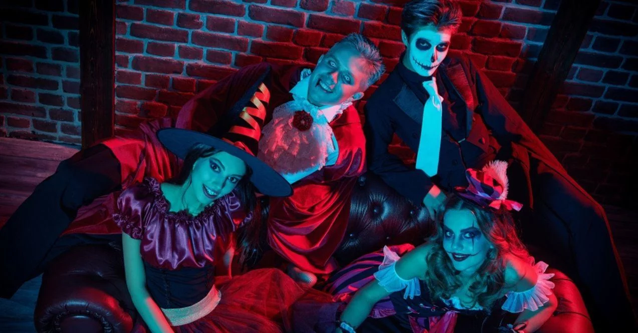 Group of teenagers taking a picture in Halloween costumes