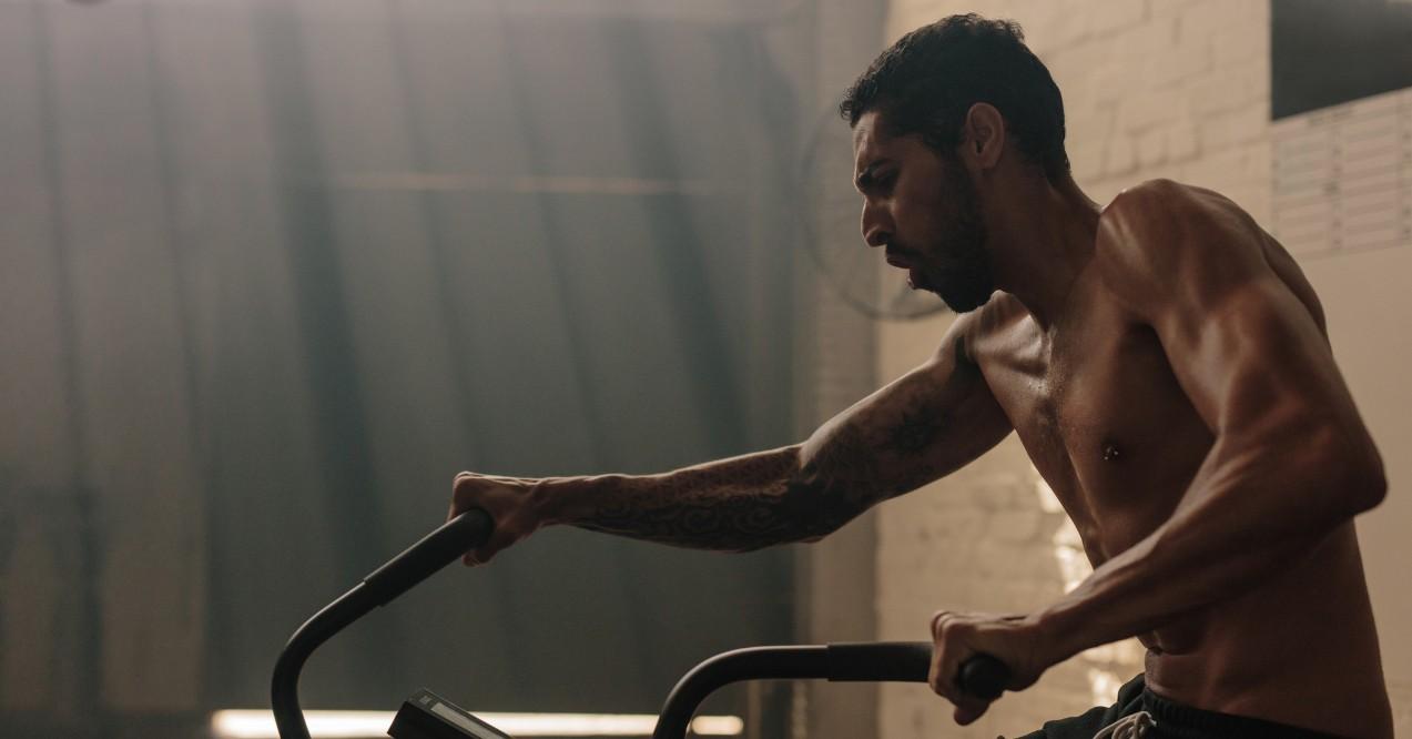 Man Working Out on Exercise Bike at Gym