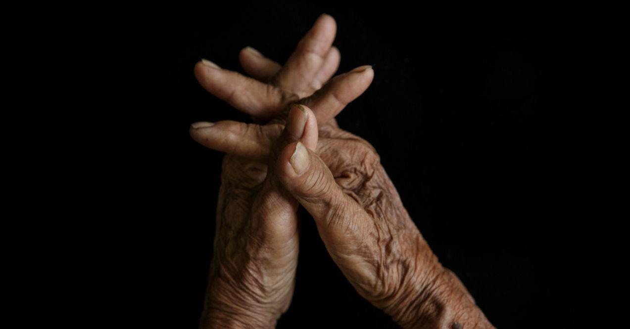 Senior Woman Holding Her Arm