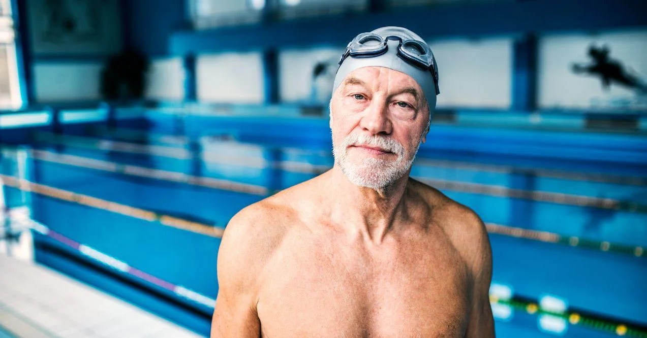 Senior Man Standing in an Indoor Swimming Pool