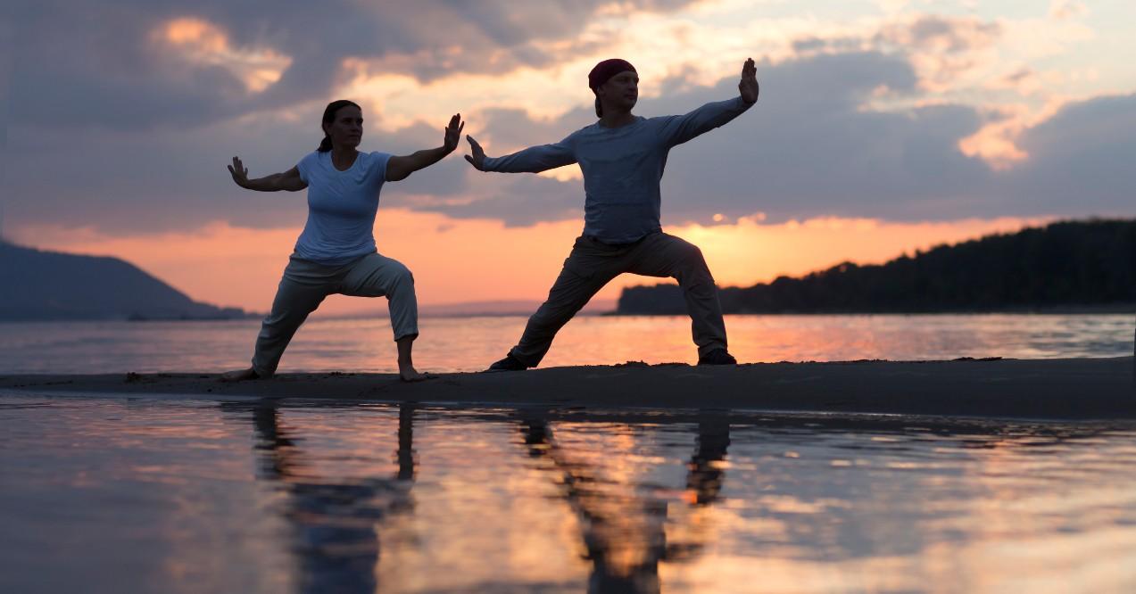 A Couple Doing Tai Chi Chuan at Sunset on the Beach