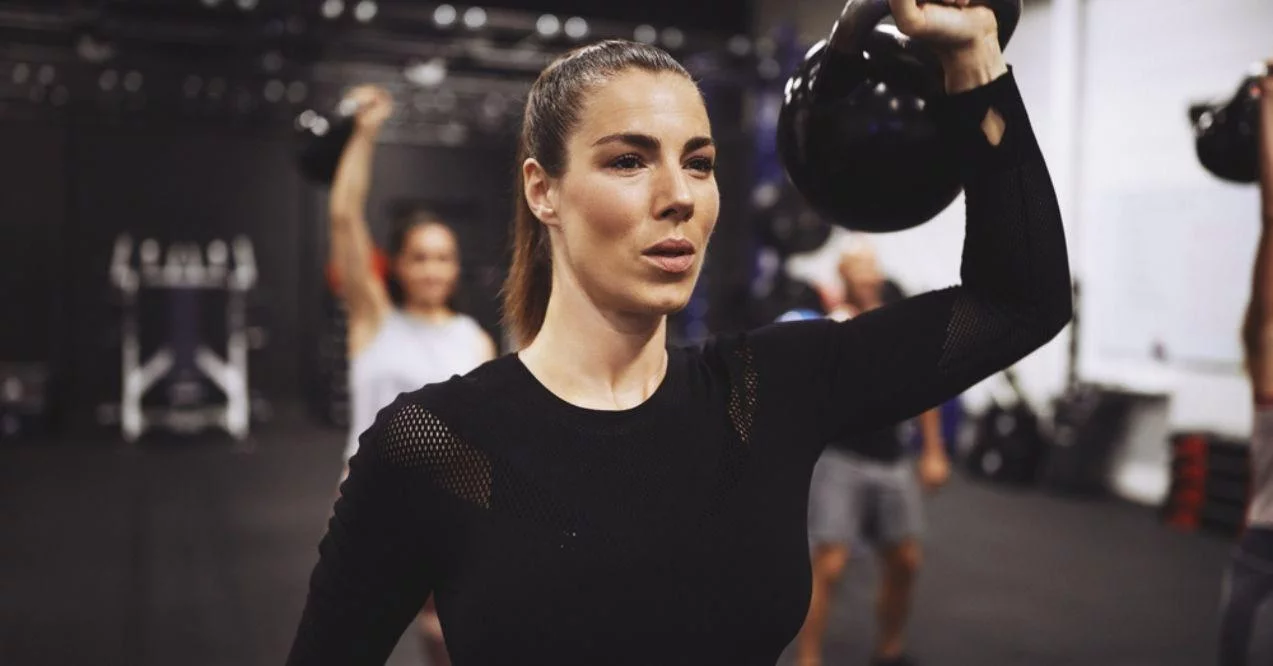 Woman raising a Dumbbell During a Strength Training Session