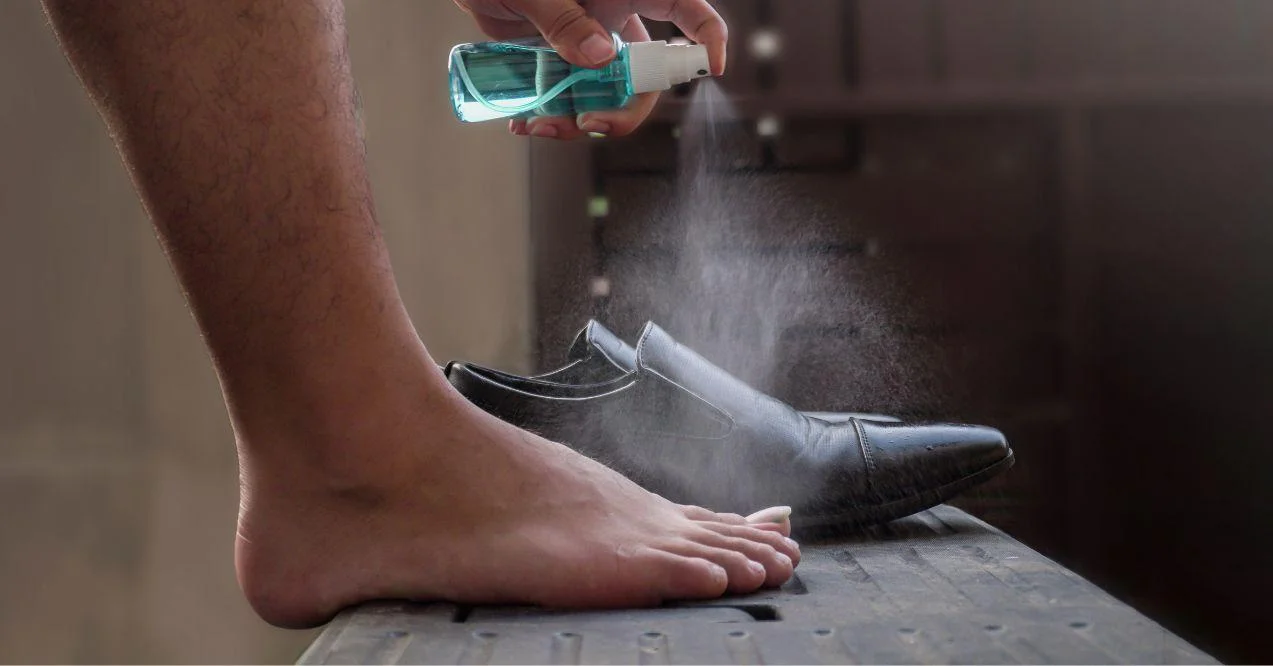 Preventive measures against infection. A man spays him feet.