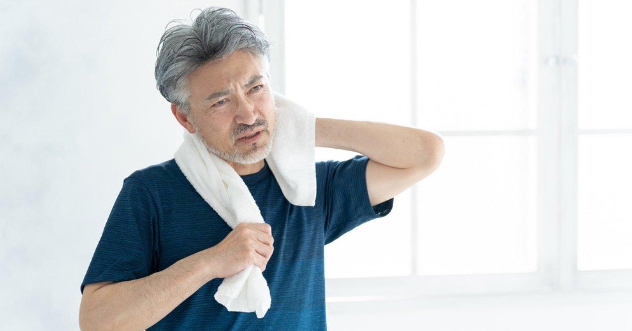 Senior Asian man experiencing muscle fatigue